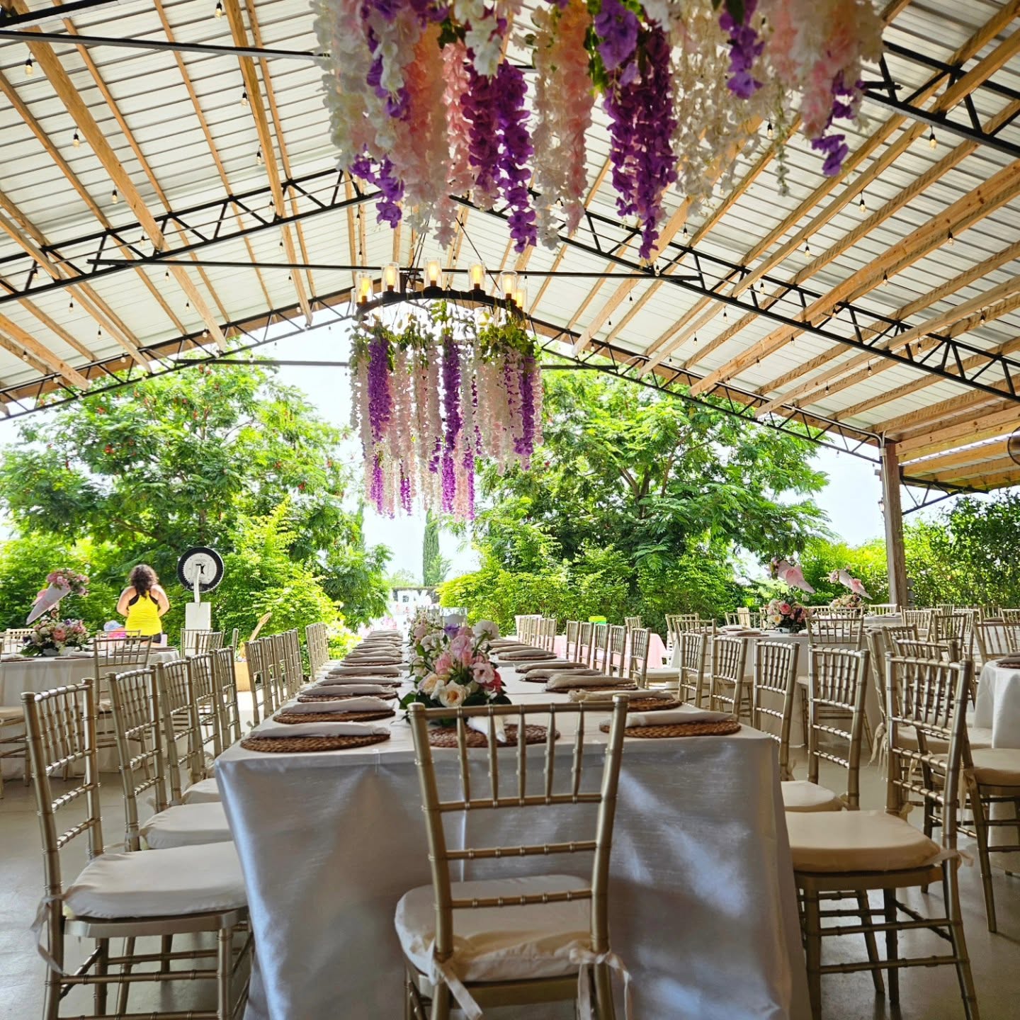 Editorial wedding reception with cascading wisteria and gold chiavari chairs